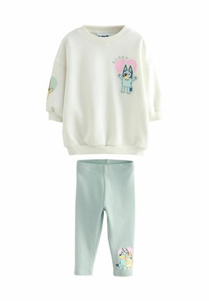 White sweatshirt with blue and pink character design, ribbed cuffs, paired with light green ribbed leggings featuring a character print.