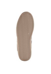 Sula med zick-zack mönster. Ljus tan färg, gummimaterial, lätt upphöjda kanter och ett centralt cirkulärt designelement.