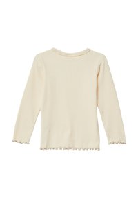 Pikkade varrukatega tipp heur kergelt beežist ribakangast, millel on ümmargune kaelus ja volangservad varrukatel ning allservas. Pehme tekstuur.