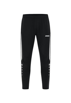 Pantalons de sport noirs au design fuselé, avec une taille élastique, le logo "JAKO" en blanc et des rayures latérales blanches avec des accents circulaires.