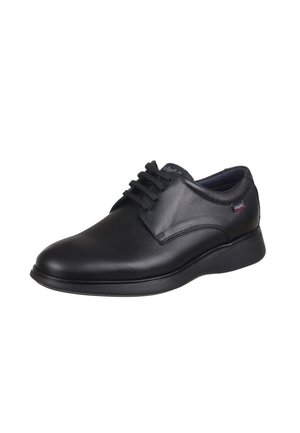 Scarpa in pelle nera con lacci, dalla finitura liscia, punta arrotondata, suola imbottita e logo discreto sul lato.