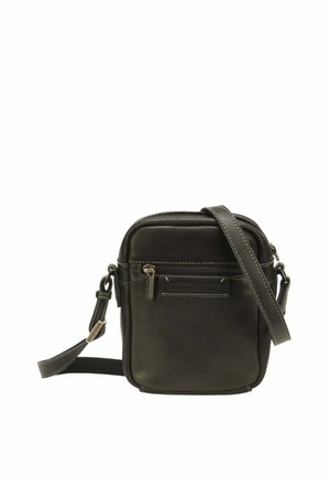 Sac bandoulière compact en cuir noir avec poche zippée avant, strap réglable et coutures visibles sur fond blanc uni.