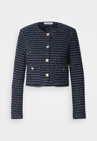 Veste courte texturée bleu foncé et noire avec manches longues et boutons dorés sur le devant et sur deux petites poches.