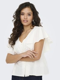 White blouse with ruffled short sleeves, V-neck, floral embroidery on the front, buttons down the center, and a relaxed fit.
