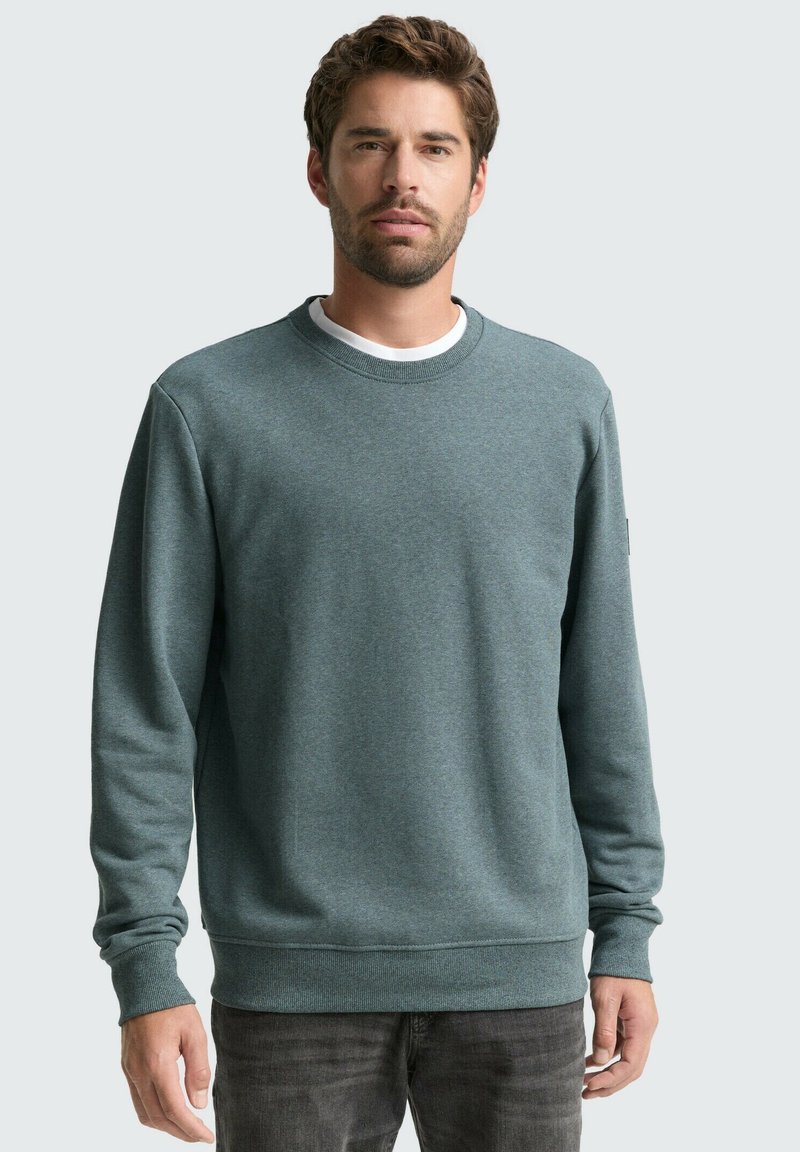 Groene sweatshirt met ronde hals, lange mouwen en geribde manchetten en zoom. Gemaakt van zachte stof, heeft het een gestructureerde afwerking.