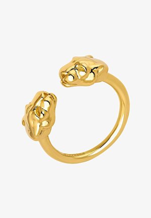 Anillo de metal dorado con cabezas de león en cada extremo, superficie lisa con detalles intrincados en las caras, diseño de banda abierta.