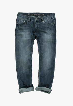 Jeans de mezclilla azul oscuro con corte recto, con dobladillos acampanados, costuras en contraste y cuatro bolsillos. Etiqueta "Solo para hombres de verdad" en la cinturilla.