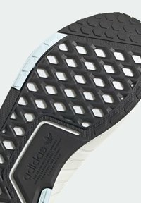 Svart gummiyttersula med ett bikakemönster, texturerad vit mellansula och en jämn ljusblå accent. Har detaljer med Adidas-märkning.