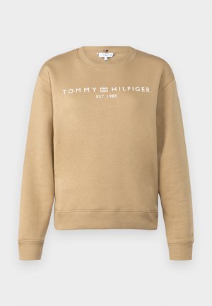 Svetlo béžová mikina s rebrovanými manžetami a spodným lemom, so znakem "TOMMY HILFIGER EST. 1985" v bielej farbe na hrudi. Mäkka a hladká textúra.