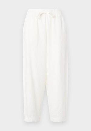 White, loose-fitting trousers made of lightweight fabric. Features an elastic waistband with drawstring and tapered cuffs at the ankles.