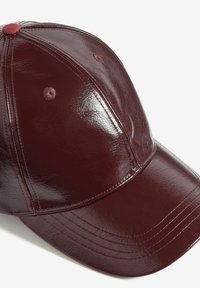 Bordová baseballová čepice z umělé kůže s lesklým povrchem, šesti-panelový design a odpovídající větrací otvory. Prošité detaily na kšiltu.