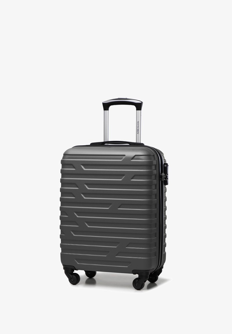 Valigia rigida grigia con superficie texturizzata, design a coste, quattro ruote e manico estensibile. Dispone di una chiusura a zip.