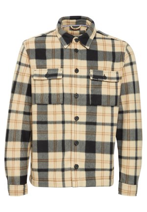 Plaid flannel shirt in beige, black, and gray. Features two chest pockets, button closures, and a collared neck. Soft, textured fabric.