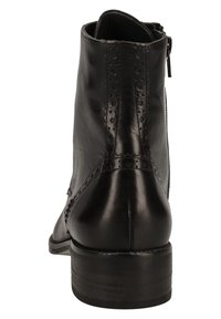 Stivale alla caviglia in pelle nera con punta rotonda, cerniera laterale, dettagli decorativi a brogue e tacco basso impilato. Texture liscia.
