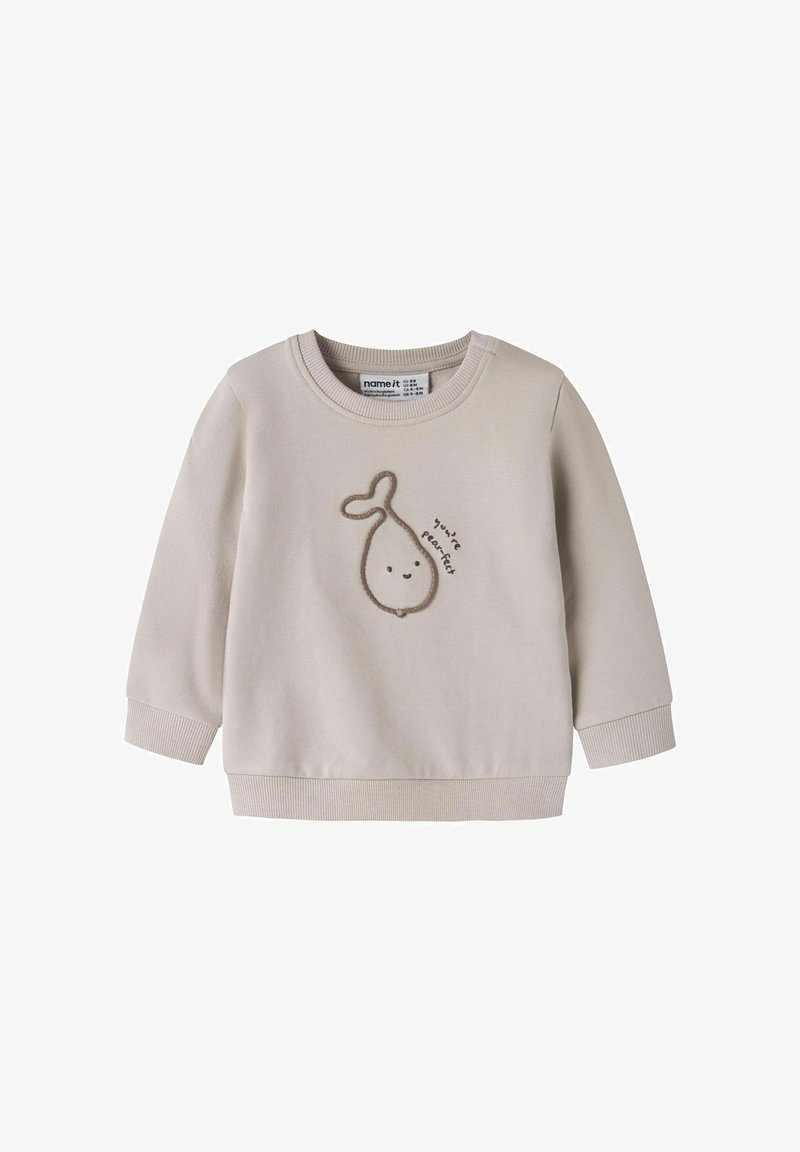 Sweat-shirt pour tout-petit beige clair avec une illustration de poire souriante et le texte "tu es poirfait" à l'avant.