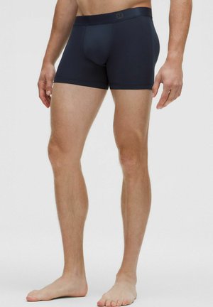 Marineblaue Boxershorts aus glattem, dehnbarem Material. Mit einem weichen Bund und Markenlogo. Kurze Beinlängen und minimales Design.