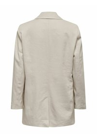 Blazer en lin beige clair avec une texture douce, des manches longues, un col cranté et une fente centrale dans le dos pour faciliter les mouvements.