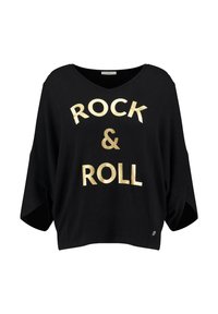 Camicia oversize nera in cotone con scollo a V, caratterizzata dalla scritta "ROCK & ROLL" in lettere dorate bold. Vestibilità ampia con maniche corte e spacchi laterali.