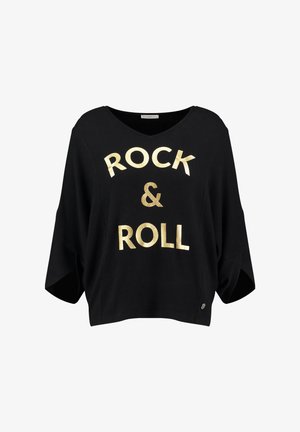 Black cotton oversized shirt with a v-neck, featuring "ROCK & ROLL" in bold gold letters. Loose fit with short sleeves and side slits.