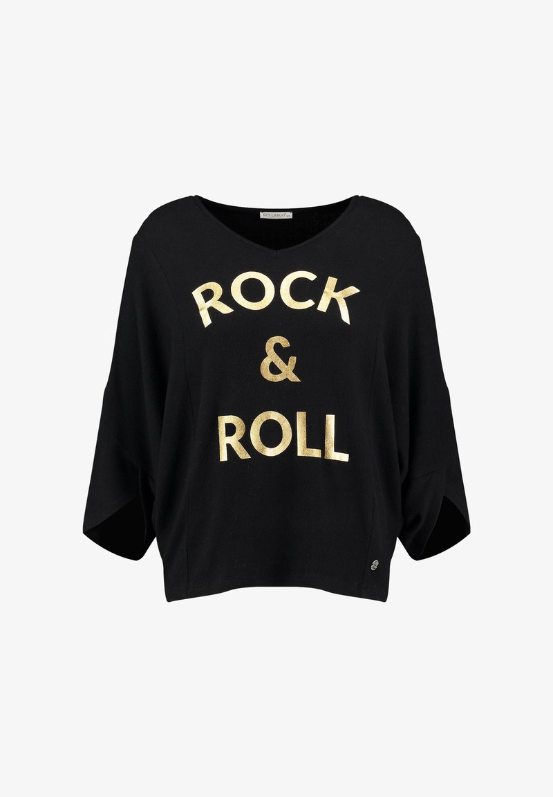 Camisa de algodón negra de corte oversized con escote en V, con "ROCK & ROLL" en letras doradas en negrita. Corte holgado con mangas cortas y aberturas laterales.