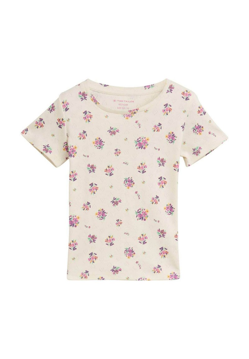 Beige T-Shirt mit kurzen Ärmeln, das ein florales Muster mit lila und gelben Blumen zeigt. Hergestellt aus einem weichen Stoff, mit einem runden Halsausschnitt und regulärem Schnitt.