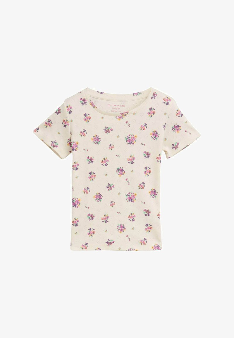 T-shirt beige à manches courtes arborant un motif floral avec des fleurs violettes et jaunes. Fabriqué en tissu doux, avec un col rond et une coupe régulière.