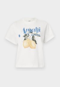 Hvid bomulds T-shirt med et grafisk design af to gule citroner og teksten "Amalfi Coast" i blå skrift. Korte ærmer, afslappet pasform.