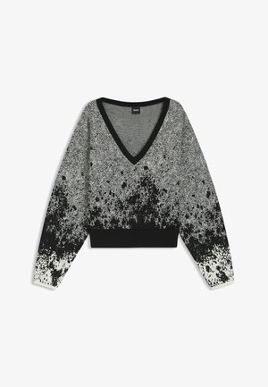 Schwarzer und weißer Strickpullover mit V-Ausschnitt, der ein Fischgrätenmuster aufweist und einen gesprenkelten Farbverlauf zum Saum hin zeigt.