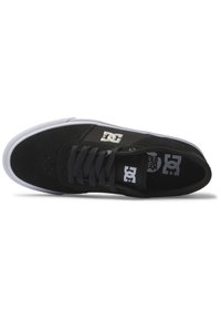 Black skate shoe with suede and fabric upper, white rubber sole, round toe, perforated detailing, and branded accents on the side and tongue.
