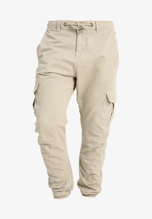 Beige cargobroek met een trekkoord in de taille, elastische boorden en zijzakken. Gemaakt van lichtgewicht stof met een gladde textuur.