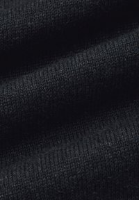 Czarne dzianinowe tło z bliska, z gładką fakturą, drobnymi nitkami i subtelnym prążkowanym wzorem, ukazujące głębię i miękkość.