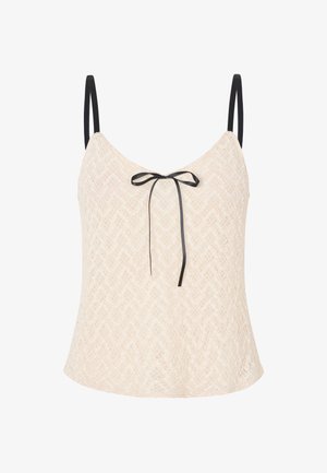 Lace top in light beige with a chevron pattern, featuring thin black straps and a front bow accent for added detail.