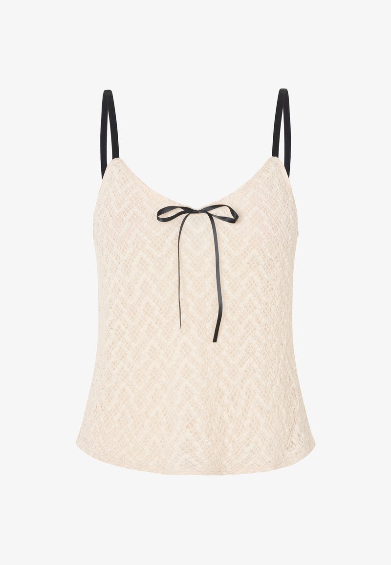 Haut en dentelle beige clair avec un motif en chevrons, doté de fines bretelles noires et d'un nœud à l'avant pour un supplément de détails.