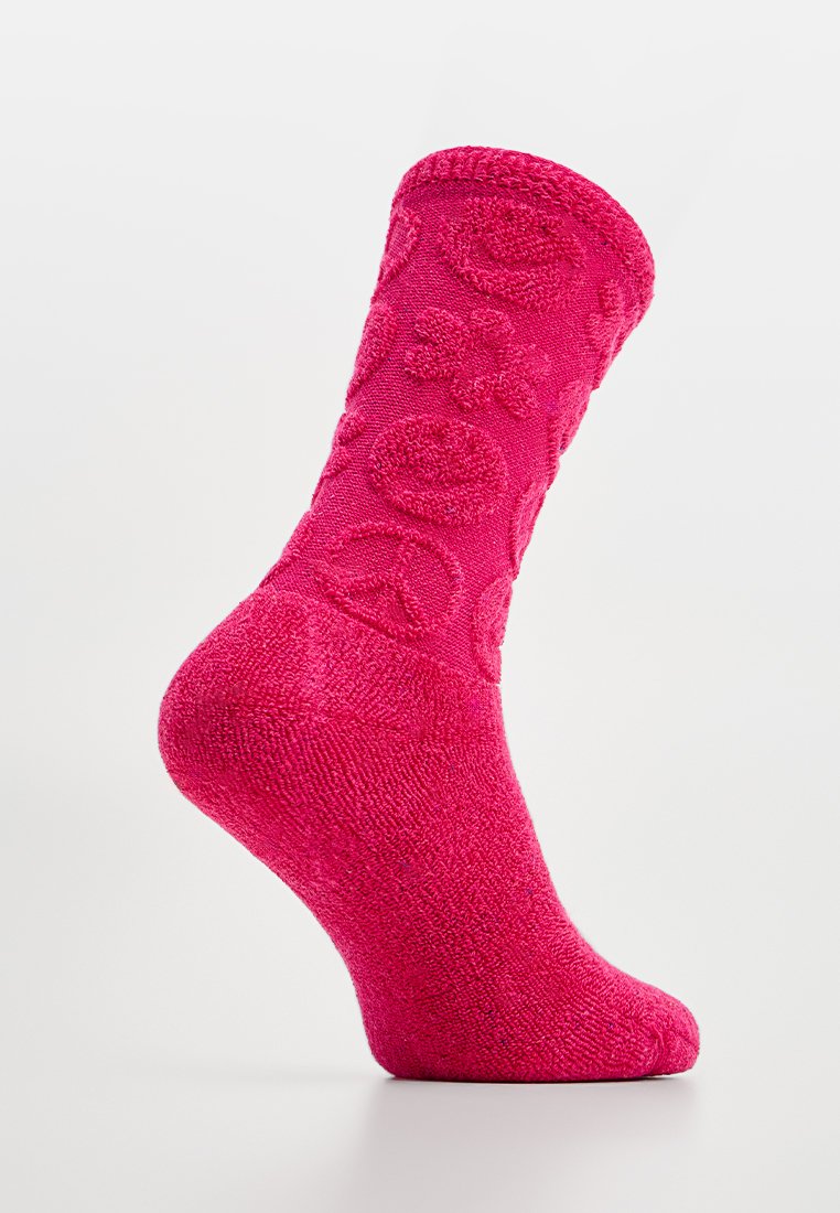 Fuchsia Socke mit strukturierten Mustern, darunter Blumen und Friedenssymbole, gerippter Bund und weicher Strickoberfläche. Geeignet für legere Trageanlässe.
