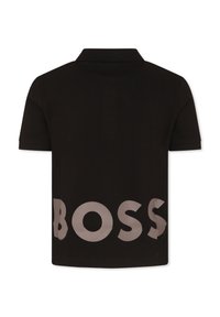 Black polo shirt with short sleeves, featuring a collared neck and large, light grey "BOSS" text printed on the back. Textured fabric.