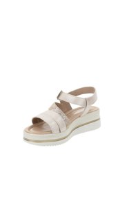 Sandal rosa con cinturini incrociati e un pannello trasparente. Presenta una soletta imbottita, una suola texture e un tacco a zeppa leggermente rialzato.