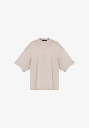 Luźna bluza z krótkim rękawem w jasnobeżowym kolorze, wykonana z miękkiego materiału, z zaokrąglonym dekoltem i szerokimi rękawami, z minimalnymi zdobieniami.