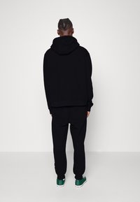 Karl Kani ESSENTIAL TRACKSUIT SET UNISEX - Tracksuit - black