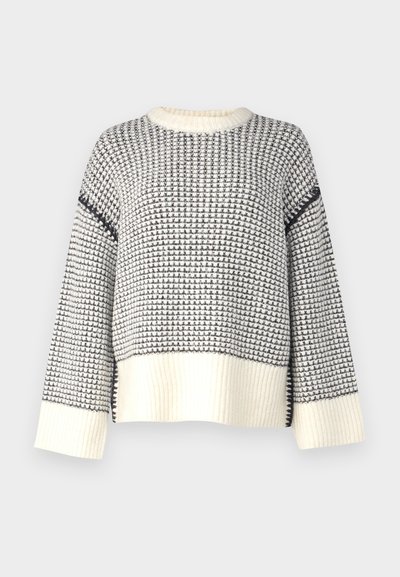 Knitted sweater featuring a textured pattern in cream and navy. Ribbed hem and cuffs, with a loose fit and round neckline.