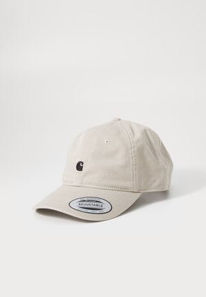 Gorra ajustable de algodón beige con un pequeño logo negro en la parte frontal y una correa redonda ajustable en la parte posterior.