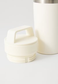 White plastic lid with a handle, designed to fit a stainless steel thermal container, featuring a smooth surface and ridged underside.