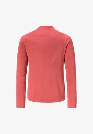 Long-sleeved top in coral color, made of textured fabric. Features a high neck and raglan sleeves with stitched seams.