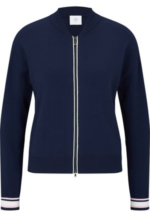 Cardigan bleu marine zippé avec col et poignets côtelés, avec des rayures blanches et roses sur les poignets et une fermeture éclair bidirectionnelle.