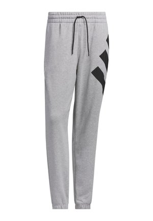 Graue Jogginghosen mit einem elastischen Bund, Kordelzug und schwarzen diagonalen Akzenten an den Seiten. Hergestellt aus weichem, strukturiertem Stoff.