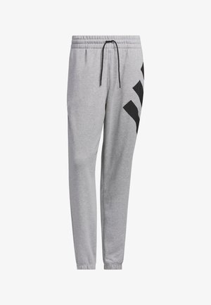 Harmaat collegehousut, joissa on joustava vyötärö, nyöri ja mustat diagonaaliset yksityiskohdat sivuilla. Valmistettu pehmeästä, tekstuuritetusta kankaasta.