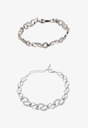 Ezüst karkötők, amelyek összekapcsolt láncszemekből állnak, sima felülettel. Az egyik ívelt mintákkal és cirkónia díszítéssel rendelkezik, míg a másik egyszerű.