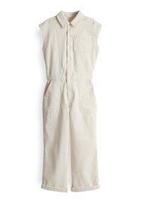 Combinaison sans manches beige en tissu résistant, dotée d'un col, d'une fermeture à boutons sur le devant, d'une poche poitrine et de deux poches latérales.