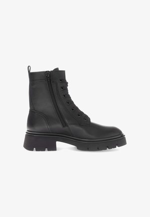 Black leather ankle boot with lace-up front, side zipper, chunky sole, and textured detailing. Structured design with a rounded toe.