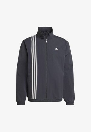 Black zip-up jacket with high collar, featuring three white vertical stripes on the left side and a small logo on the chest. Lightweight material.