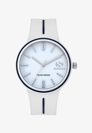 Valkoinen silikoni-kello, jossa on metallinhohtoinen hopeinen kellotaulu. Kellossa on tummansininen yksityiskohta, hopeiset viisarit ja minimalistiset tuntimerkit. Brändilogo näkyvissä.